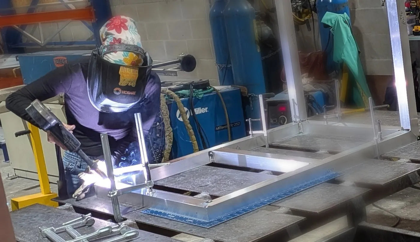 Welding an aluminum cabinet frame in the Fire Islands shop